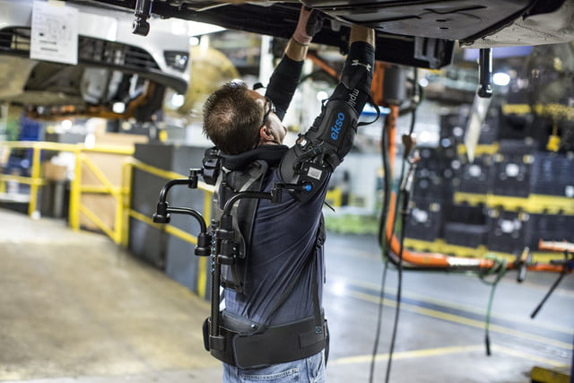 Automotive worker assembling overhead vehicle